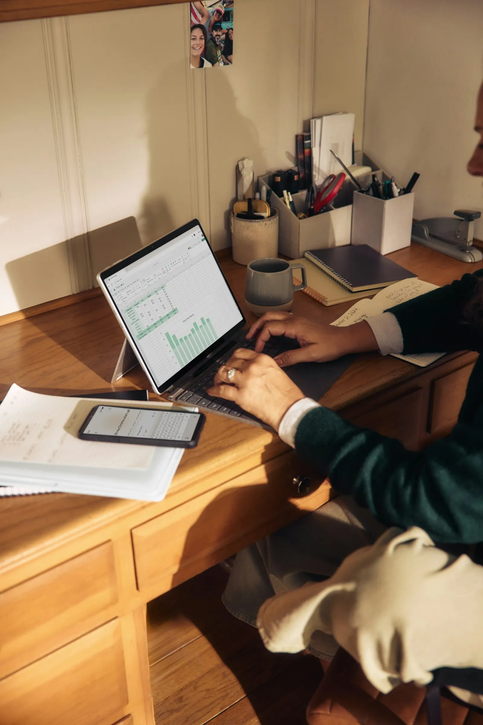 A laptop and notes on a wooden desk